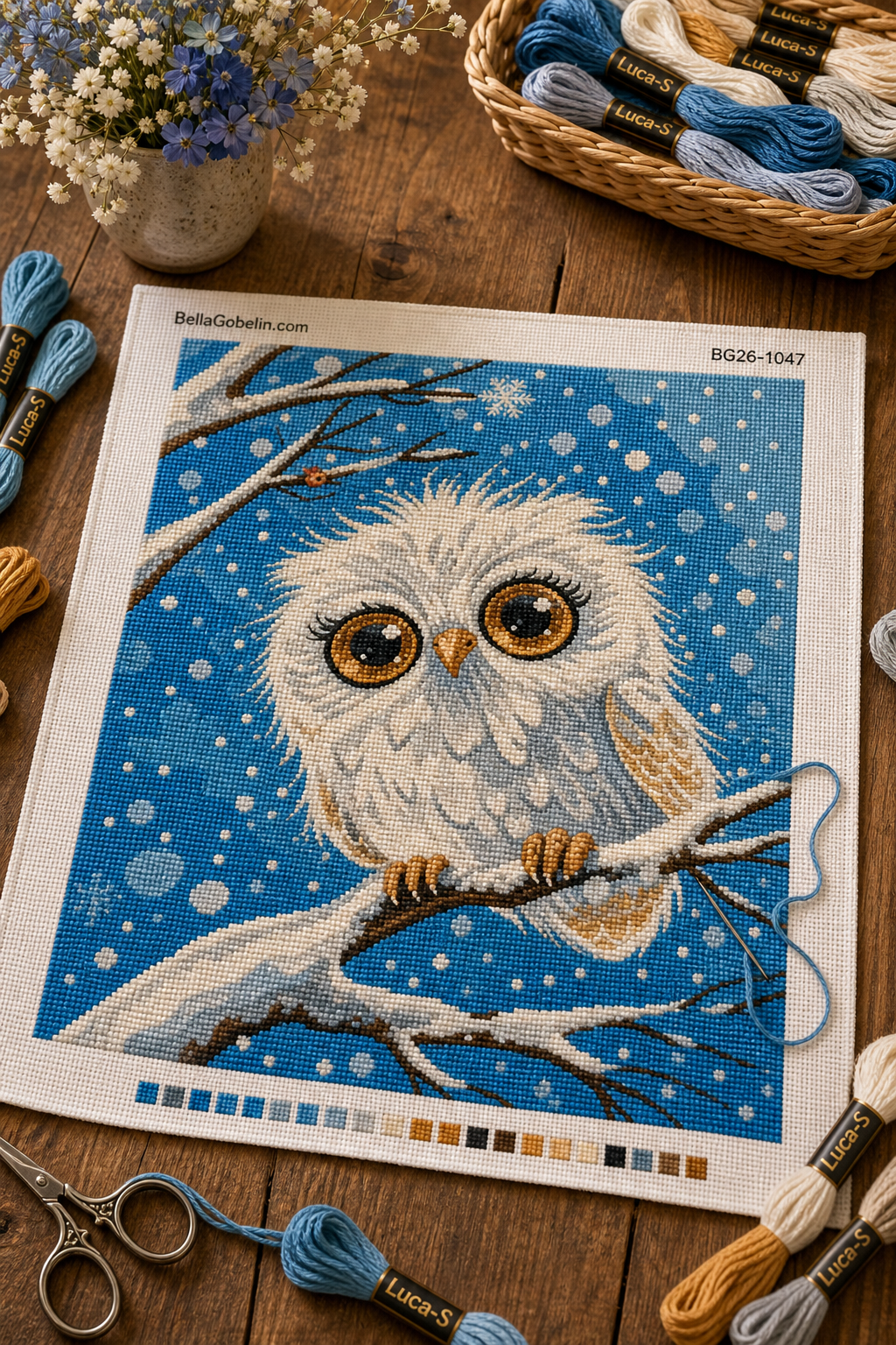 Owl sitting on a snowy branch